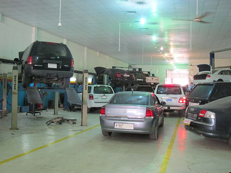 Workshop floor with multiple vehicles in different stages of work