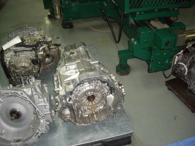 Multiple transmission units laid out on the workshop bench