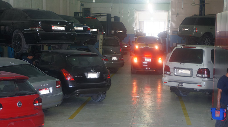 Premium and family vehicles on lifts inside the workshop
