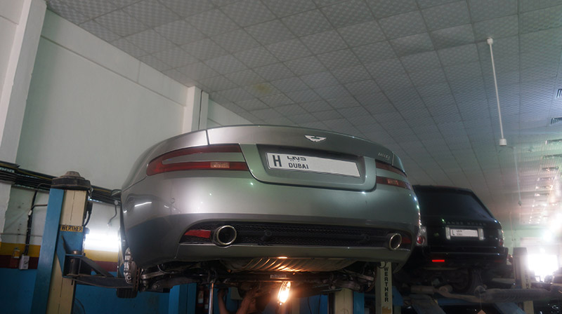 Aston Martin underside being inspected from below